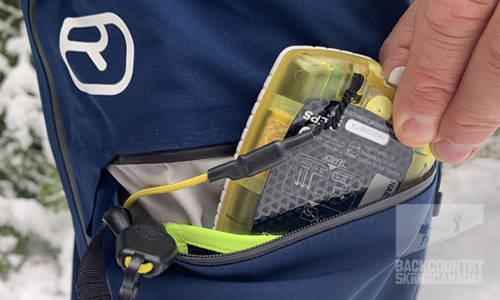 There are two front zippered pockets with one having an integrated mesh pocket and clip for your transceiver.